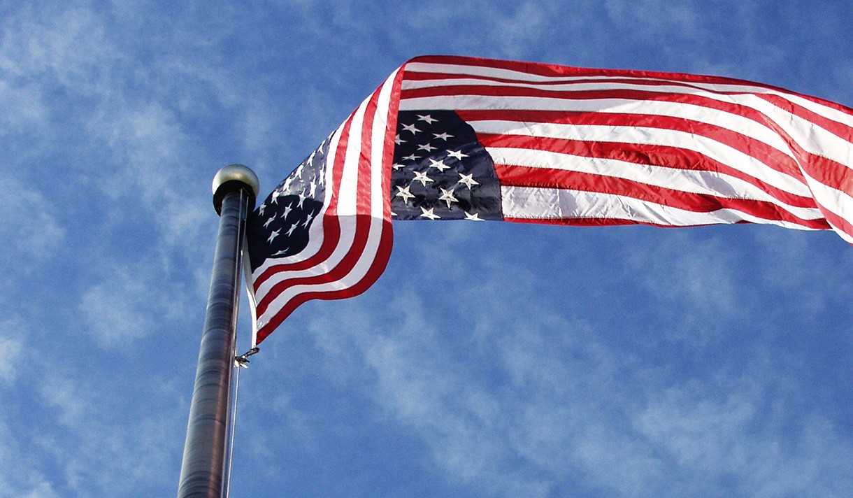 An American flag waving in the air