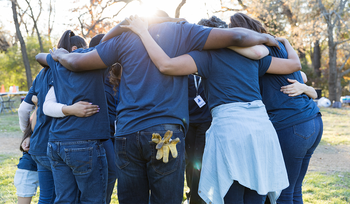 Student volunteers in a huddle