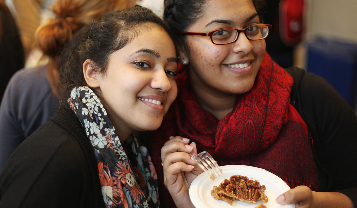 Two students with a slice of pie