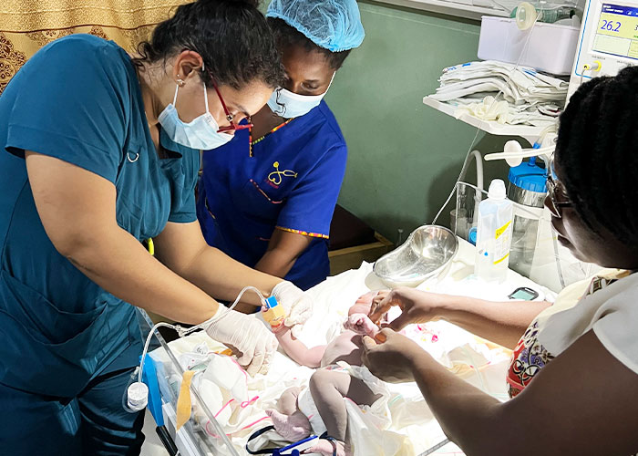 NYITCOM student Elianna Sanchez tends to a newborn baby at Hawa Memorial Saviour Hospital in Osiem (Ghana).