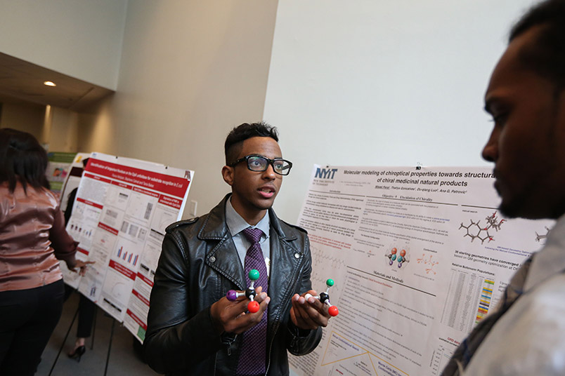 Misael Pena used DNA strands to demonstrate his research project on molecular modeling conducted with fellow student Thallys Goncalves.