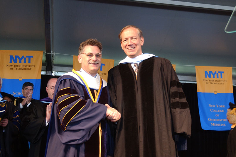 <strong>Gov. George Pataki Addresses NYIT Graduates in 2002</strong> At the 2002 NYIT Commencement, graduates heard from former New York Gov. George Pataki. He is pictured shaking hands with NYIT President Edward Guiliano, Ph.D. The commencement address was the first following the tragic events of 9/11. As reported in the first issue of <em>NYIT Magazine</em> published in summer 2002, Pataki alluded to New York's remarkable resilience following the attacks and urged his audience to "never give up," regardless of the challenges ahead. "The fact that you [graduates] are here today receiving degrees from one of New York's finest institutions of higher learning is a sure sign that you are not quitters," he said. Pataki also received an honorary degree from NYIT.