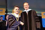 <strong>Gov. George Pataki Addresses NYIT Graduates in 2002</strong> At the 2002 NYIT Commencement, graduates heard from former New York Gov. George Pataki. He is pictured shaking hands with NYIT President Edward Guiliano, Ph.D. The commencement address was the first following the tragic events of 9/11. As reported in the first issue of <em>NYIT Magazine</em> published in summer 2002, Pataki alluded to New York's remarkable resilience following the attacks and urged his audience to "never give up," regardless of the challenges ahead. "The fact that you [graduates] are here today receiving degrees from one of New York's finest institutions of higher learning is a sure sign that you are not quitters," he said. Pataki also received an honorary degree from NYIT.