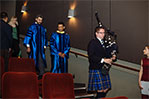 Faculty speakers Leo de Sousa and Sinan Caykoylu followed a ceremonial bagpiper to the stage.