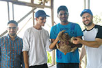 The students pose with a baby sloth. Photo by Patrick Quio Valdivia