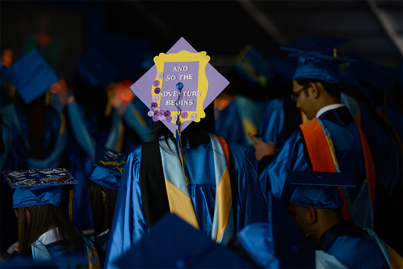 An excited graduate looks towards a bright future.
