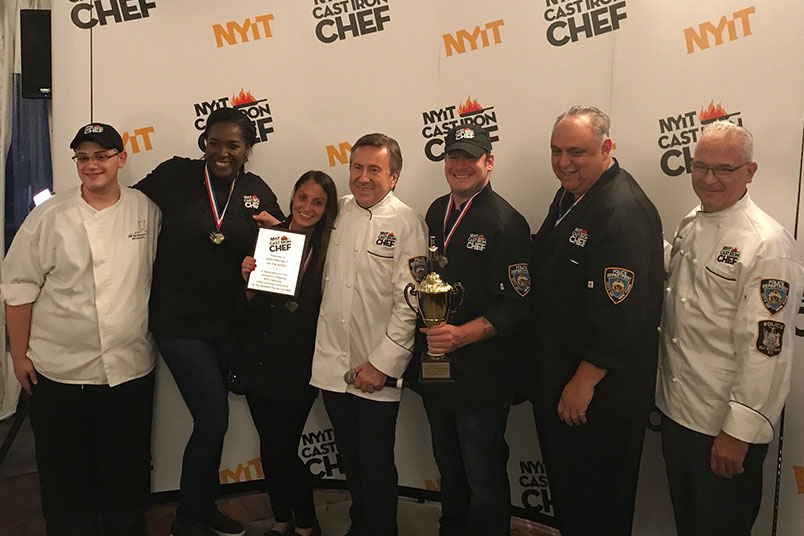 The NYPD team receives its award from Daniel Boulud and Robert Rizzuto.
