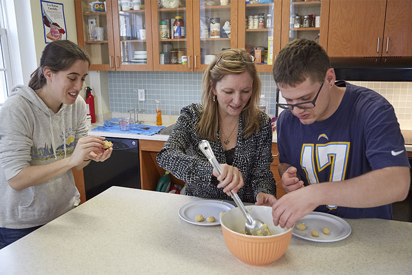 Gina Frisina, director of Independent Living, shows junior Olivia Mirabello and sophomore Max Zukin how to make matzo ball soup.