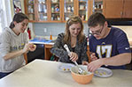 Gina Frisina, director of Independent Living, shows junior Olivia Mirabello and sophomore Max Zukin how to make matzo ball soup.