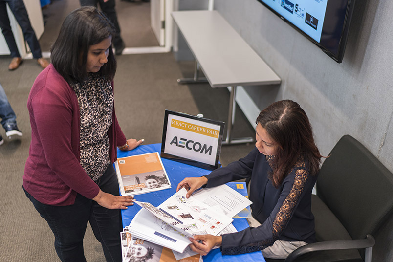 A student meets with a recruiter from AECOM.