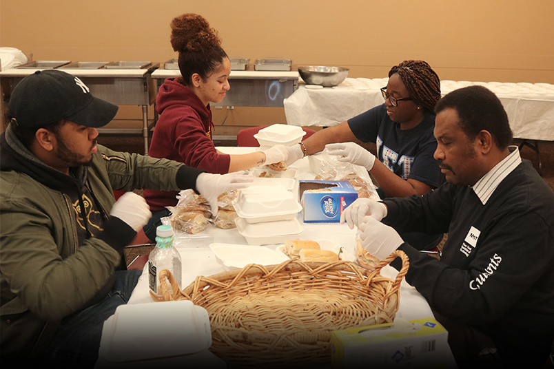 Volunteers prep meals and distribute care packages to the homeless at Saint Paul the Apostle Church in Manhattan.