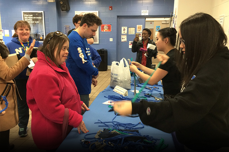For N.avigate Y.our C.ollege, participants teamed up with students from NYIT’s Vocational Independence Program (VIP) to complete a scavenger hunt. Here, the group makes dog toys for animals in location shelters.