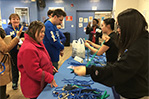 For N.avigate Y.our C.ollege, participants teamed up with students from NYIT’s Vocational Independence Program (VIP) to complete a scavenger hunt. Here, the group makes dog toys for animals in location shelters.