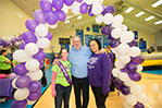 Megan Siemers, director of student life at NYIT-Manhattan (left) and Marisol Bazile, associate director of student involvement and inclusion at NYIT-Long Island (right), walk with Michael Scarpa-Burnett, who started Relay for Life at NYIT 10 years ago.