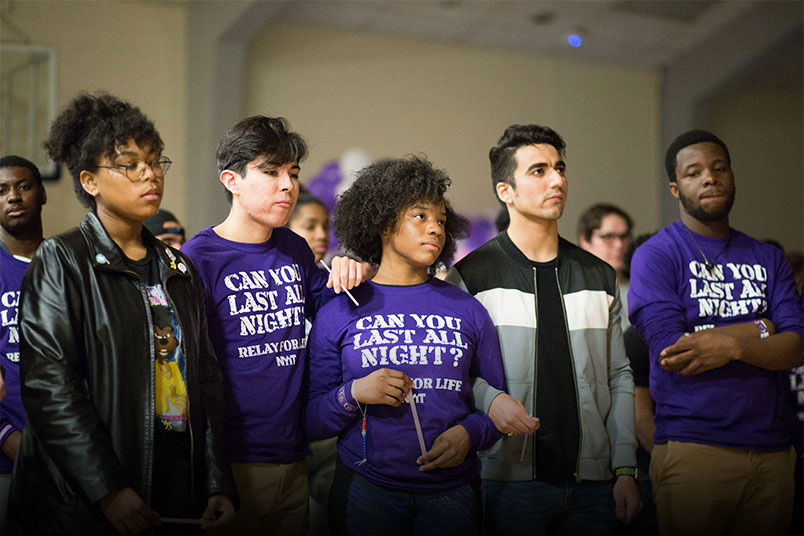 NYIT students Ayesha Cade, Andrew Ulloa, Kaela Bell, Himanshu Negi, and Kehinde Williams embrace during a moment of silence in memory of those who have lost their battle to cancer.