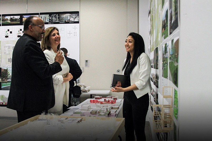 NYIT student Hannah Mapoy (right) explains her project to Deans Sheldon Fields and Maria Perbellini.