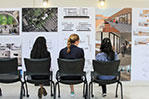 Students discussing their classmates design proposals at the final review.