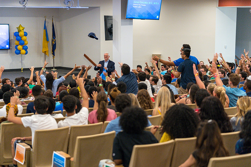NYIT President Hank Foley tossed t-shirts to the new students.