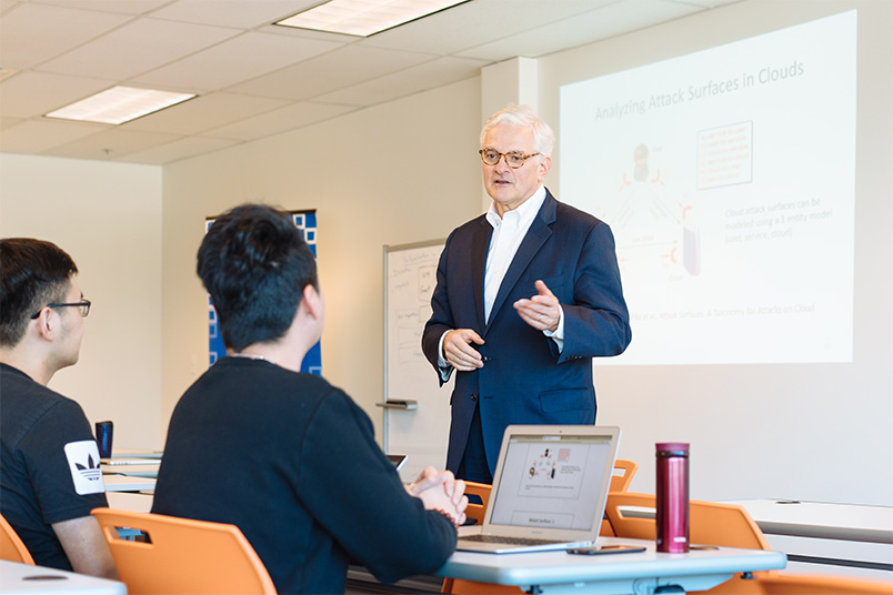 President Foley addresses a data centre security class led by Assistant Professor of Computer Science Amin Milani Fard.