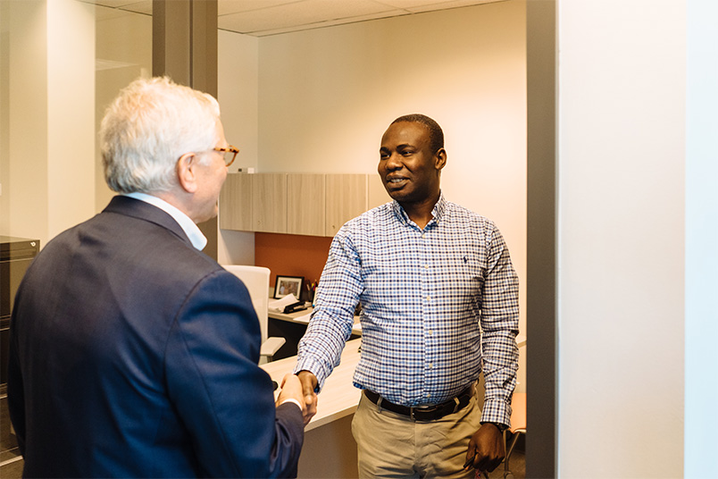 Assistant Professor Tokunbo Makanju meets with President Foley.