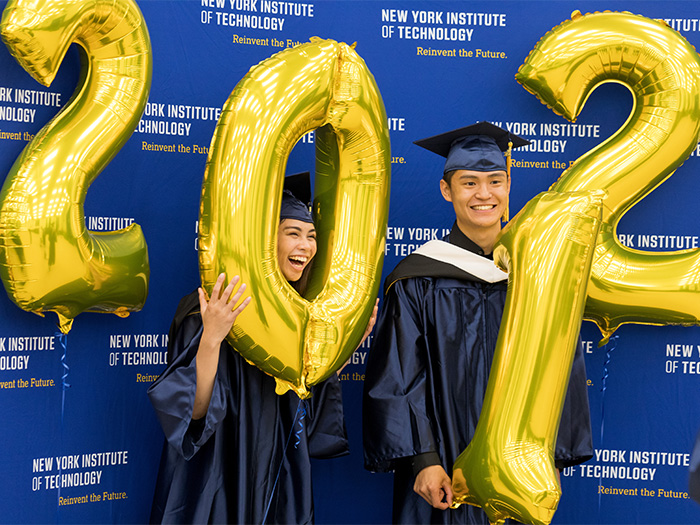 Undergraduates and soon-to-be alumni have fun at the photo booth during the Stroll Across the Stage event on the Long Island campus.