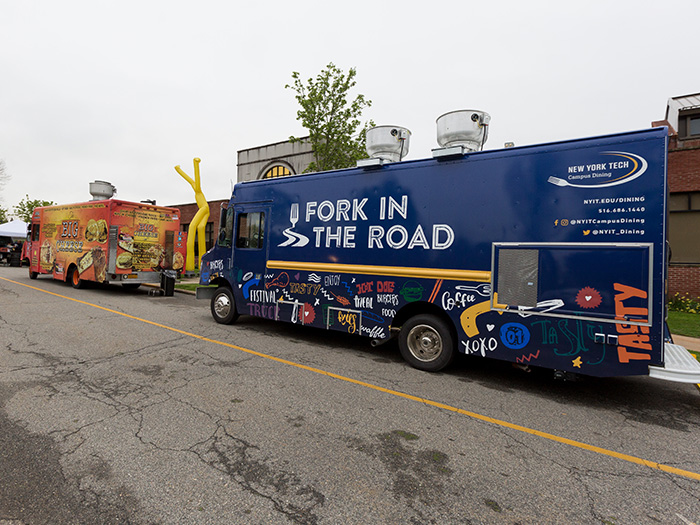 Food trucks, including New York Tech's new Fork in the Road, line up on the Long Island campus prior to the start of the Glam Ball Extravaganza: Drive-in and Drag event.