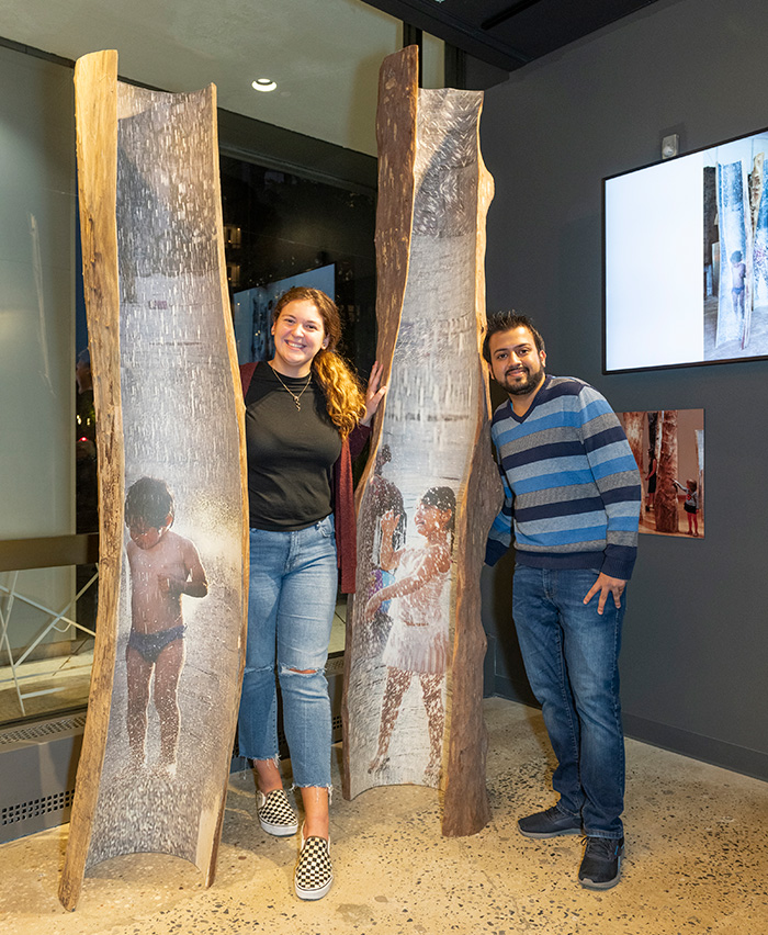 Lillian Pratt, president of the Student Government Association on the New York City campus, and Mohammad Tariq Jamal (B.S. ’18), president of the Graduate Student Association on the New York City campus, pose with <em>Girl</em> and <em>Boy</em> at the opening.