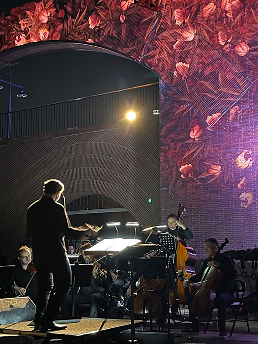 The animated flower renderings serve as a backdrop for the orchestra during the two-day performance.