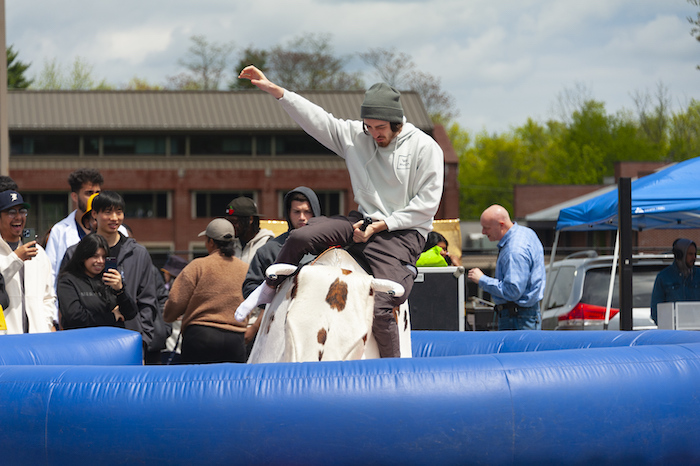 On the Long Island campus, a student tries his best to stay on the mechanical bull.