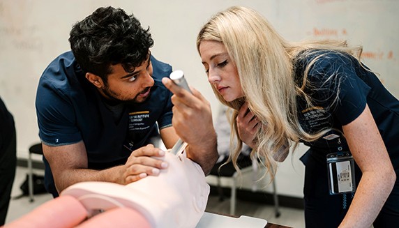 NYITCOM-Arkansas Student Doctors Yashwanth Makkapati and Makayla Goggins practice intubating a task trainer during a simulation event in Jonesboro.