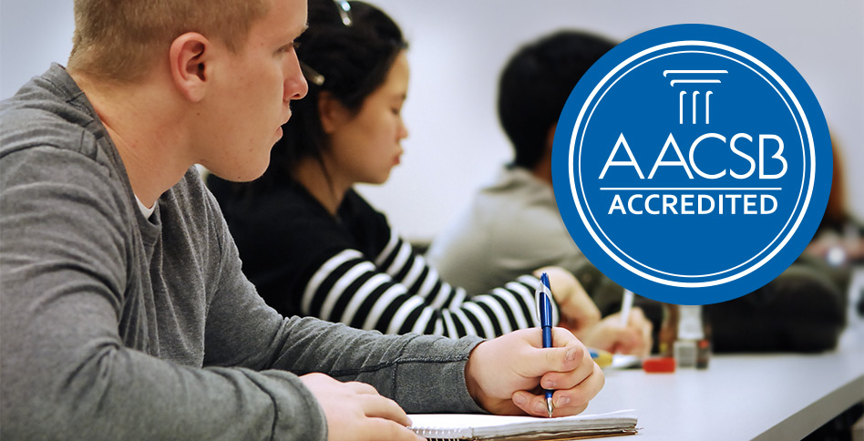 NYIT student in class with the AACSB logo