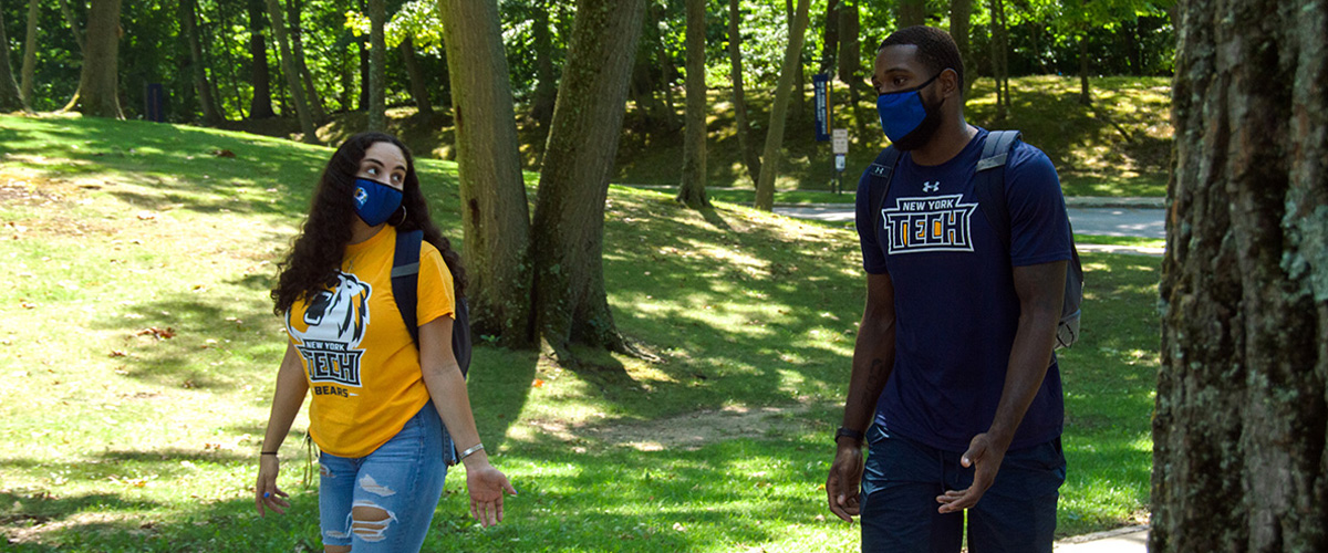 Two New York Tech students walking on Long Island campus.
