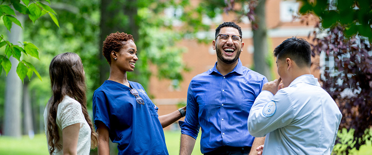 Group of smiling students on Long Island campus.