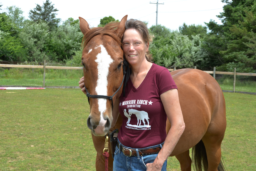 Eileen Shanahan standing with a horse.