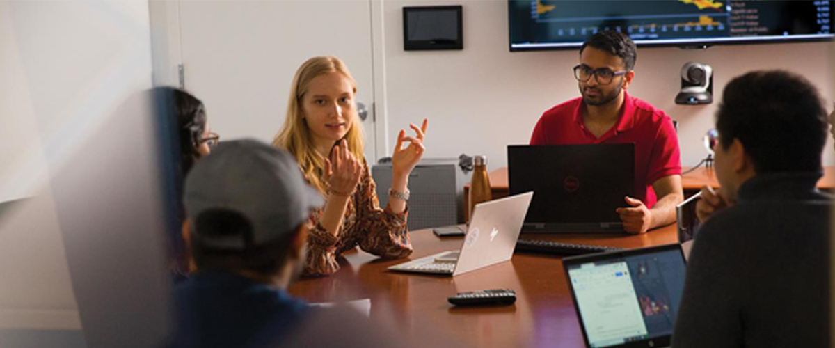 Students sitting around a conference room table