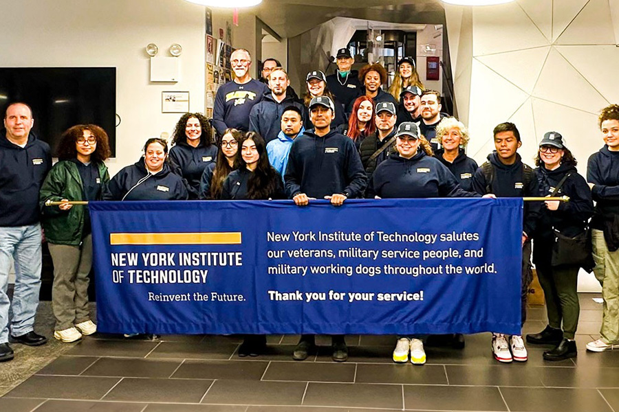 Group of New York Tech student veterans, faculty, and staff in front of a New York Tech banner