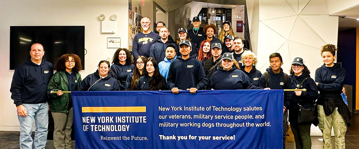Group of New York Tech student veterans, faculty, and staff in front of a New York Tech banner