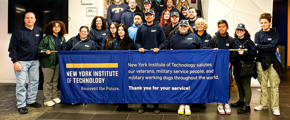 Group of New York Tech student veterans, faculty, and staff in front of a New York Tech banner