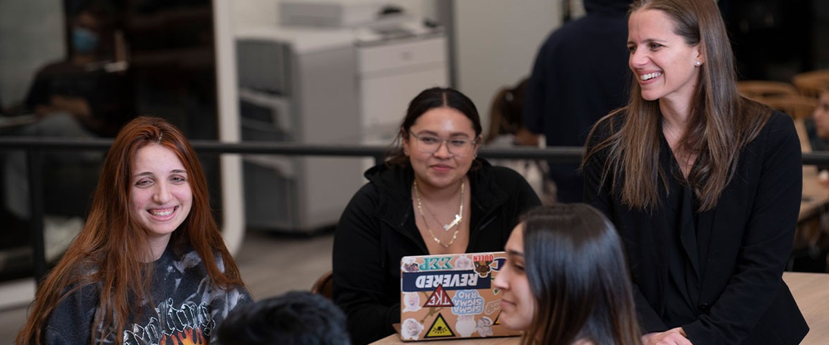 Advisor with students on the Long Island campus