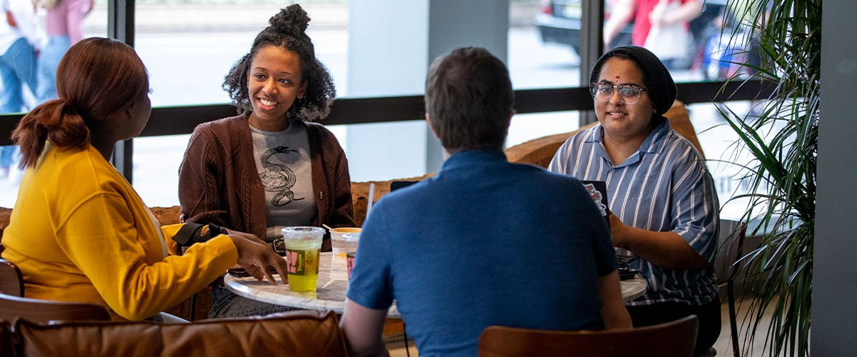 New York Tech students sitting at a table