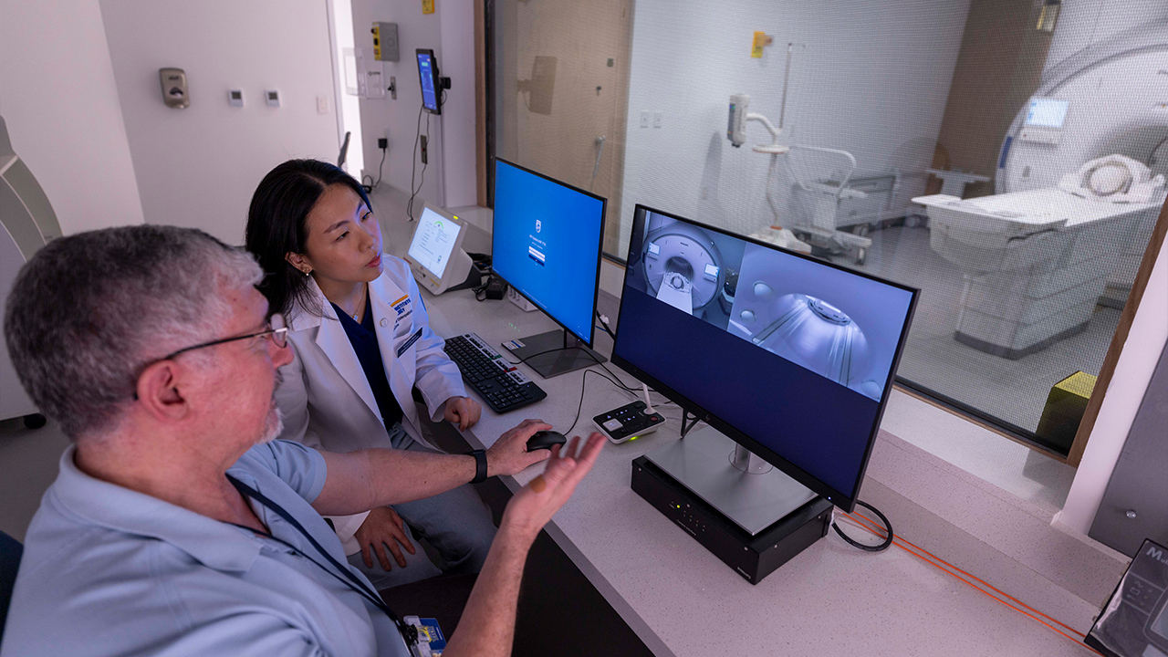 Two researchers work on a state-of-the-art fMRI machine.