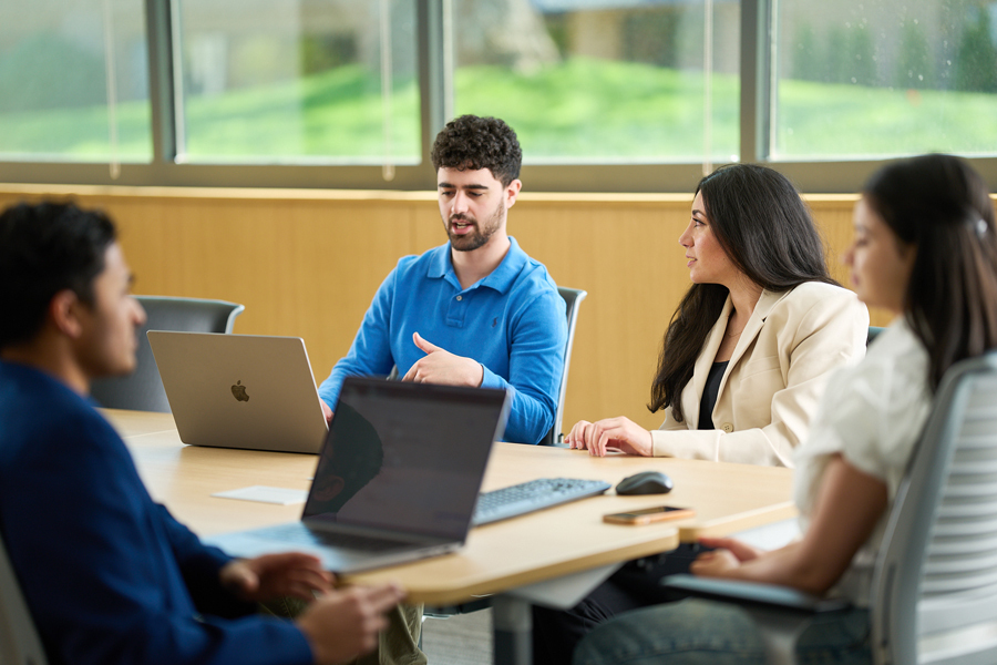 A group of students are in a meeting in a conference room.
