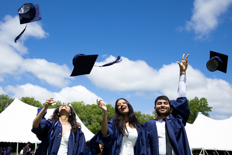Graduating students throwing their hats in the air