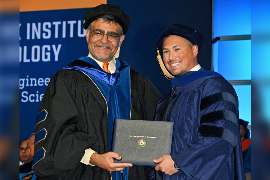 Dean Babak Beheshti presents Michael Kohler with his degree