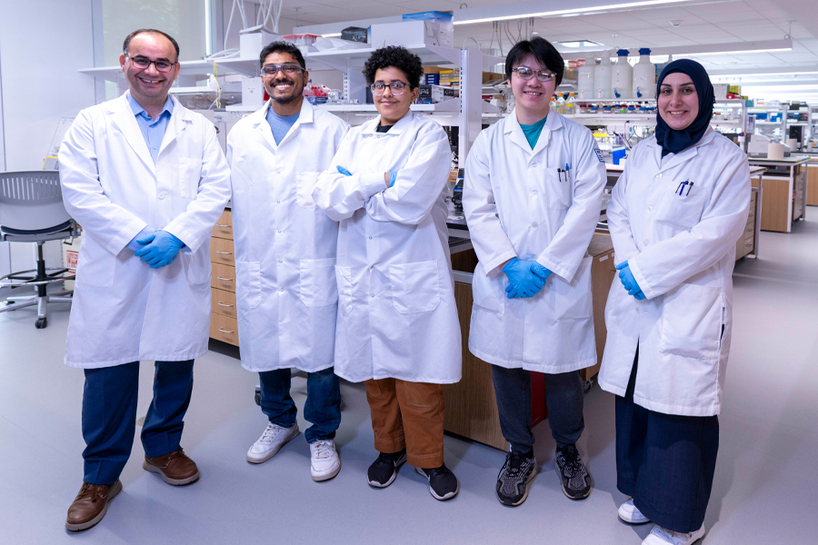 Students with their professor in a lab