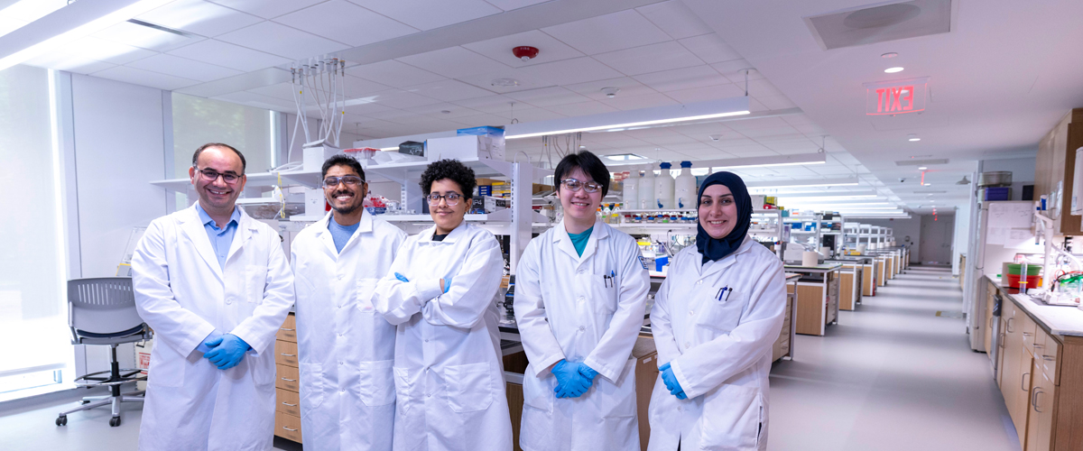 Students with their professor in a lab