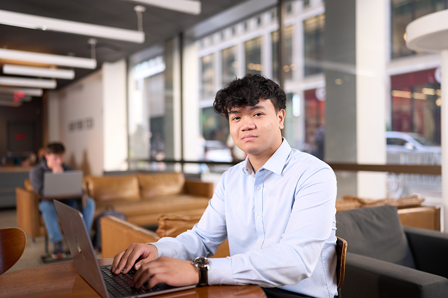 A student works on his laptop at the New York City campus.