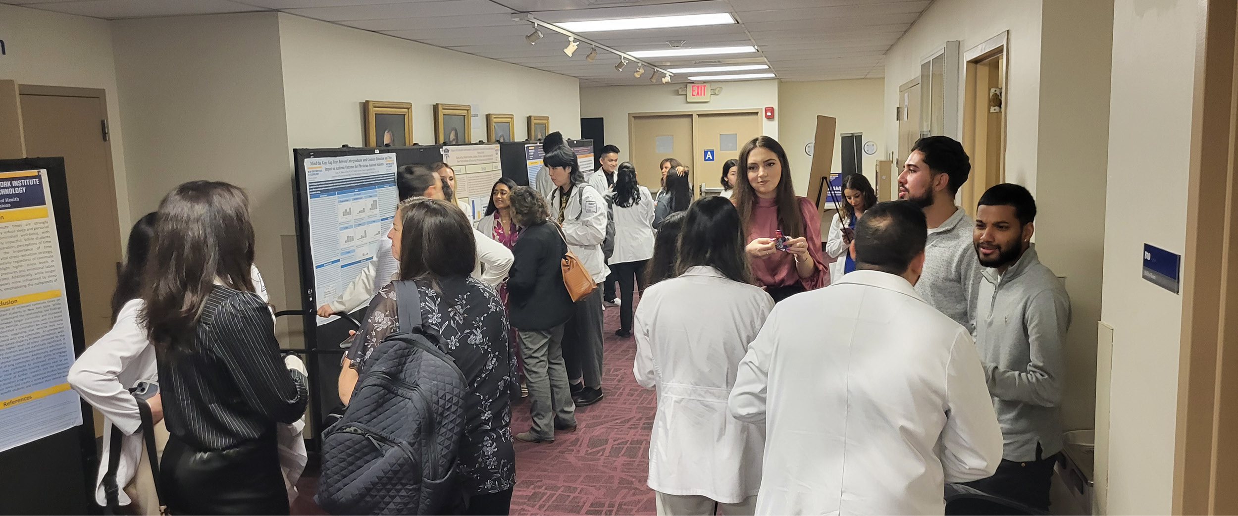 Attendees looking at student poster presentations