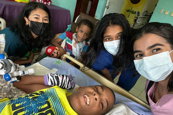 Medical students around a child patient.