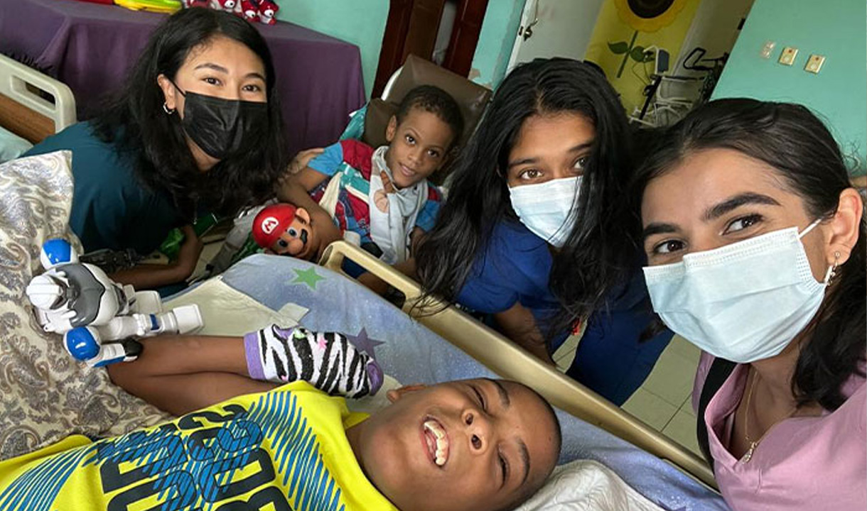 Medical students around a child patient.